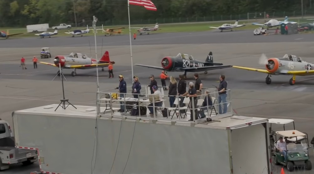 A group of people standing around an airport.